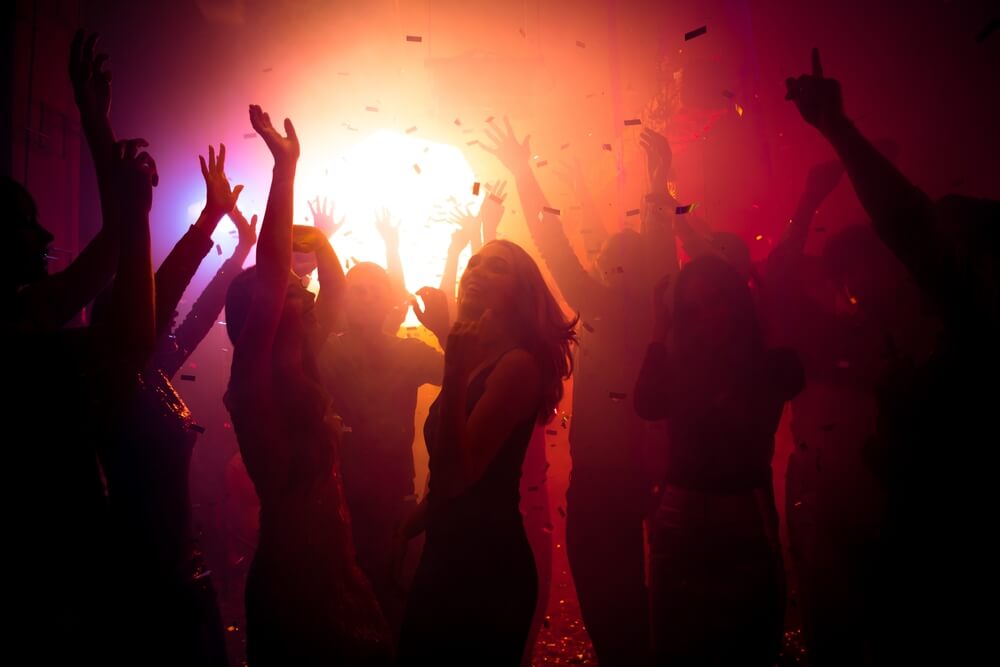 Photo of carefree people dancing at a party.