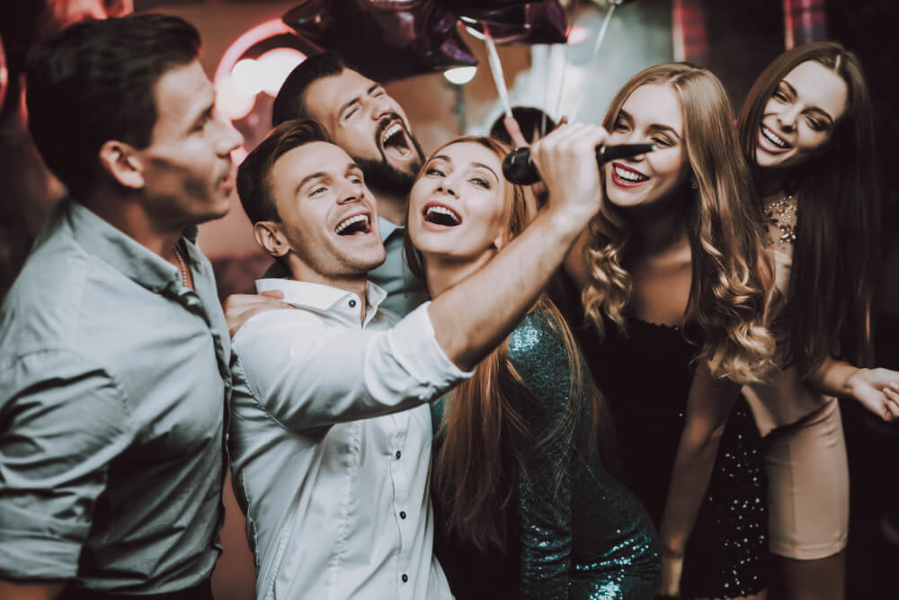 A group of young people at the karaoke party.