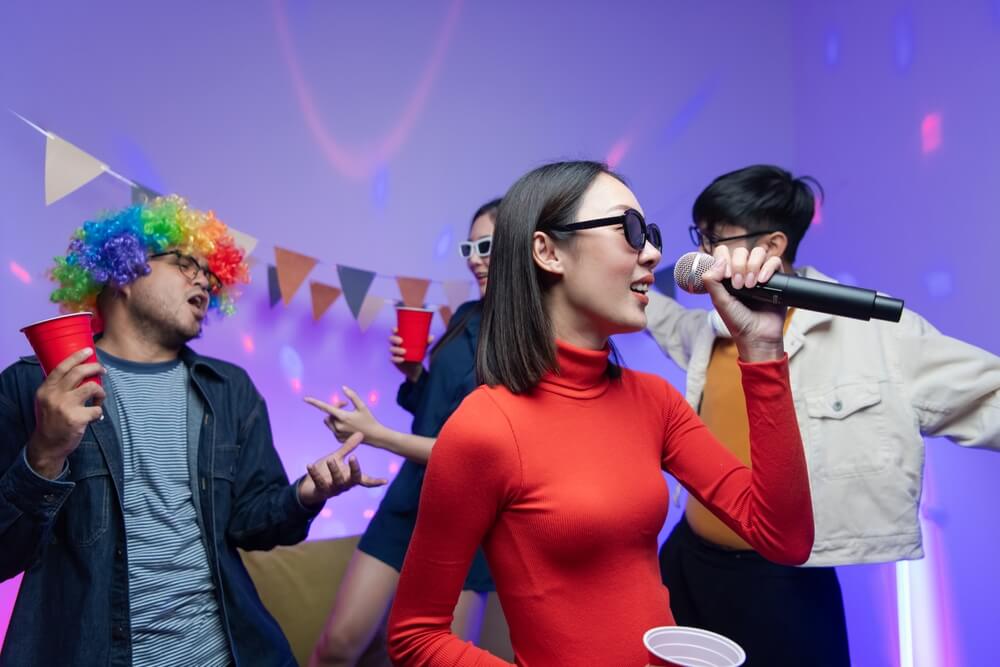 A group of young people at the karaoke party.