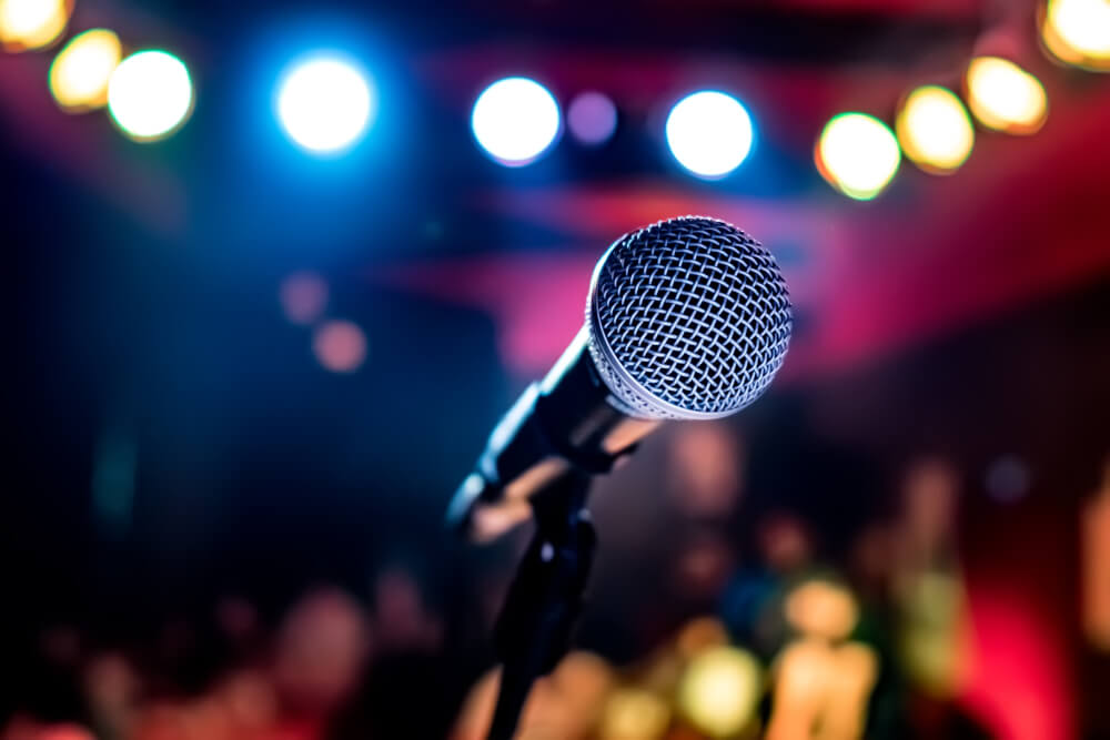 Microphone on stage against a background of auditorium. 