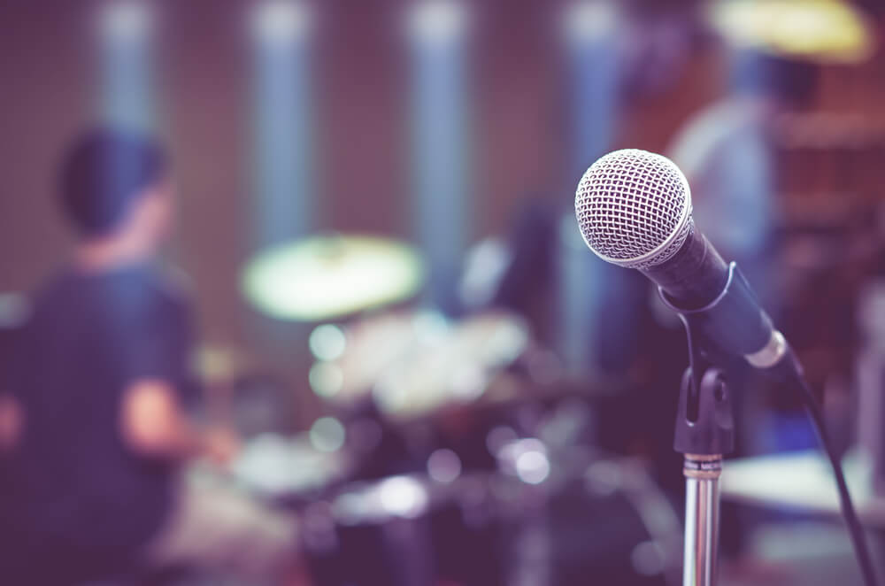 Close up of microphone on musician blurred background.