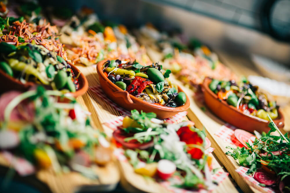 Mediterranean cuisine mixed on wooden cutting board.