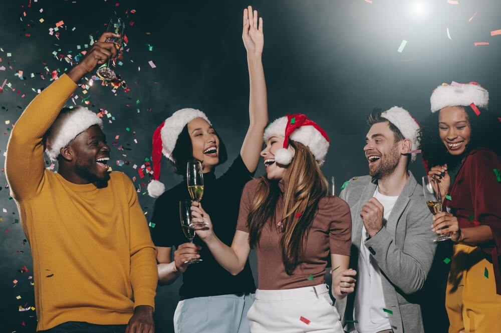 A group of young people having fun at the Christmas karaoke party.