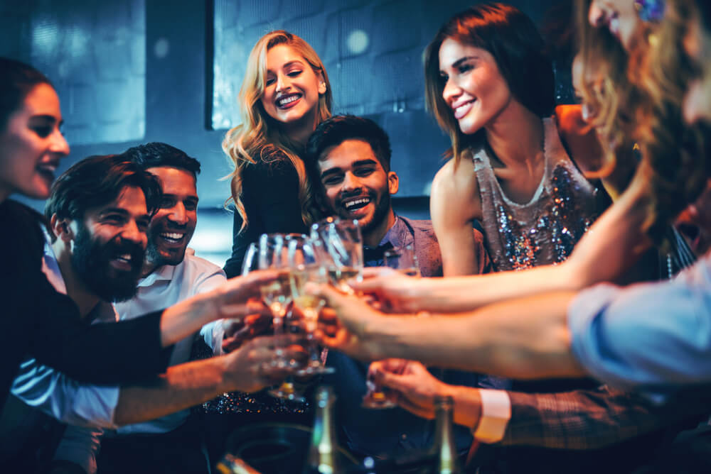 Young professionals toasting with champagne to celebrate their achievements.