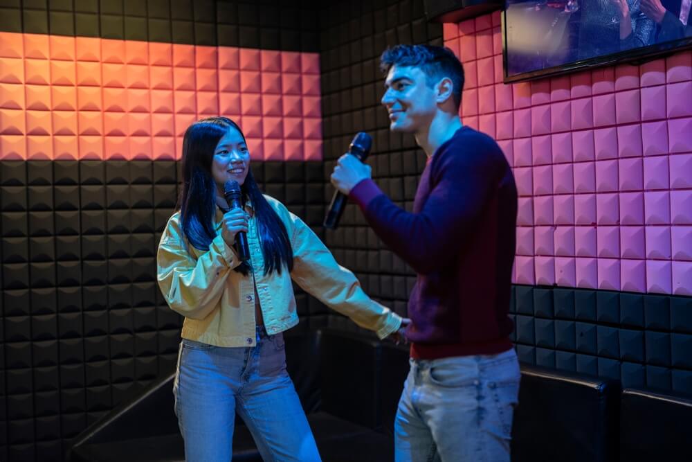 Couple singing and dancing at the karaoke date.